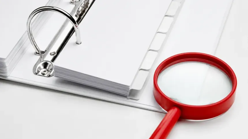 An organised overview of printed documents fanned out on a desk